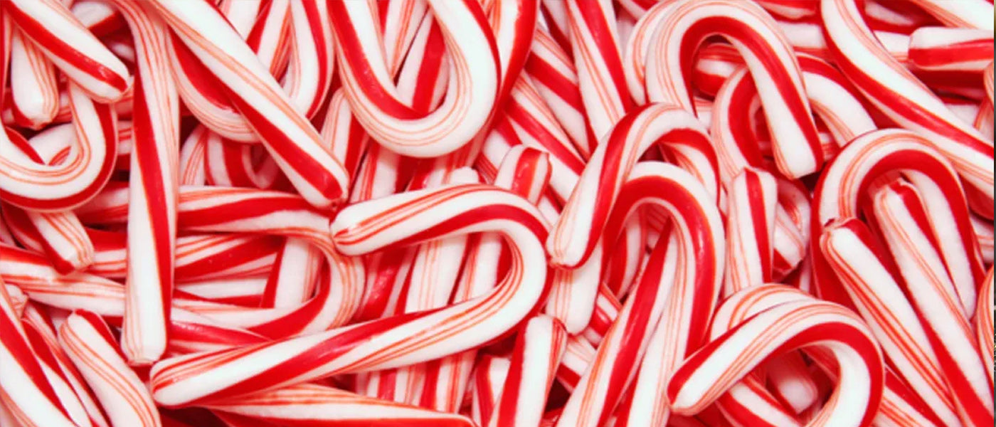 Premium Photo  Tasty red candy cane in a cup on red background